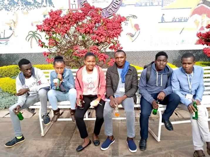 Comrades gathered on a bench in the community